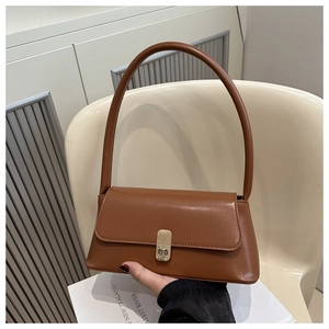 Detail of a brown PU leather shoulder bag featuring a gold metal buckle closure