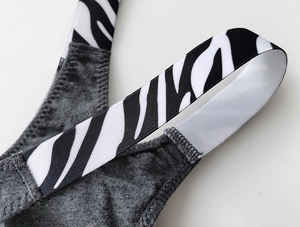 Detailed macro view of zebra pattern elastic strap and dark gray cotton fabric stitching