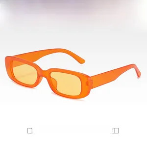 Detailed close-up of retro square sunglasses with orange plastic frame and yellow lenses