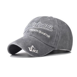 Detailed embroidery of New Orleans French Quarter on a washed cotton grey baseball cap