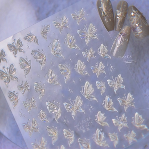 Macro view of 3D laser butterfly nail decals showing holographic effect on model nails
