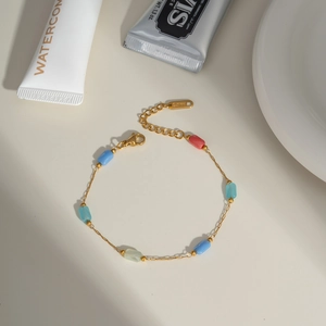 Detail of gold chain bracelet with colorful crystal beads and lobster clasp closure