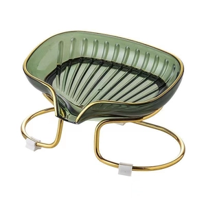 Leaf-shaped emerald green soap dish with golden metal stand and drainage design