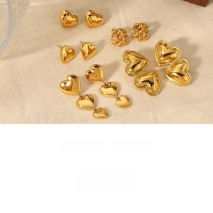 Detailed view of high-gloss gold plated titanium steel heart and woven earrings