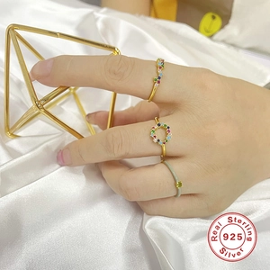 Three elegant 925 sterling silver rings with colorful gemstones on a female hand