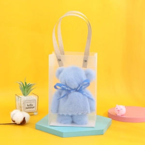 Detailed view of a cute blue bear-shaped towel gift in a clear Just For You carry bag