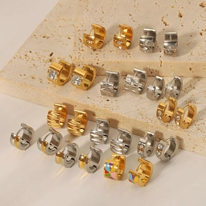 Elegant 18K gold plated stainless steel huggie earrings collection on stone display
