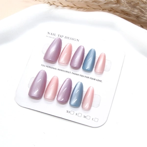 Handmade pearlescent almond press-on nails set in pink, lavender, and grey-blue colors