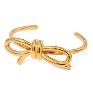 Elegant gold plated stainless steel bow knot open bangle with a polished minimalist finish