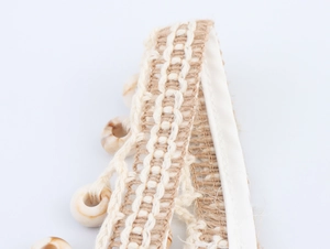 Macro shot of bohemian woven waist belt with natural shells and cotton rope textures