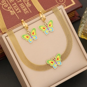 Parure papillon dorée avec pendentif en émail sur coffret en cuir champagne