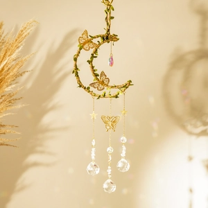 Detailed close-up of a moon-shaped dream catcher with crystals and gold butterflies