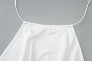 Detail of white halter neck top with thin straps and square neckline design
