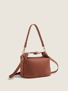 Brown woven leather tote bag with top handle and gold-tone hardware on white backdrop