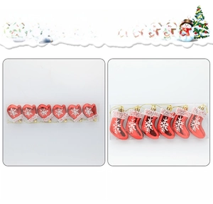 Detail of red Christmas glove and sock ornaments with white glitter snowflake patterns