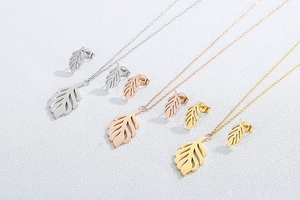 Detailed view of hollow leaf necklace and earring sets in silver, rose gold, and gold
