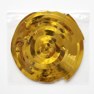 Close-up of golden spiral PVC hanging ornaments in packaging for party ceiling decor