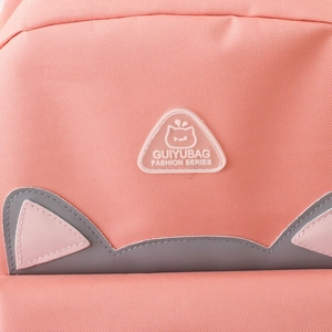 Close-up of pink backpack fabric texture with cute cat ear design and rubber brand logo