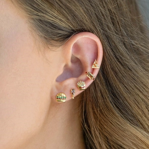 Macro shot of 18K gold plated food-themed stud earrings featuring burger and fries designs
