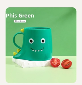 Detail of creative green dinosaur ceramic mug with back fin handle on white rock base