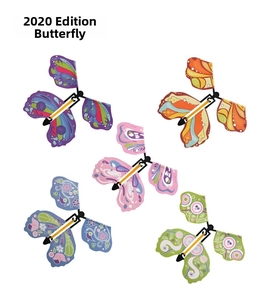 Set of five colorful flying butterfly magic toys with intricate patterns and rubber bands