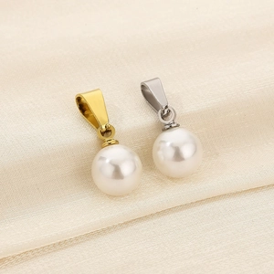 Macro view of white pearl pendants with gold and silver titanium steel clasps
