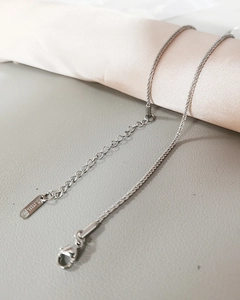 Macro detail of silver stainless steel twist chain with lobster clasp and extender