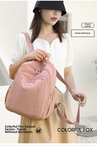 Pink waterproof nylon backpack with multiple zipper pockets and elastic side compartments