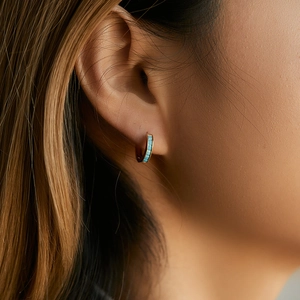 Minimalist 18K gold brass hoop earrings with blue stone inlay worn by a model