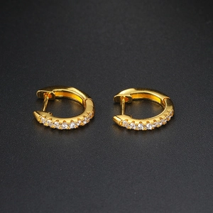 Close-up of gold-plated hoop earrings with sparkling white cubic zirconia stones