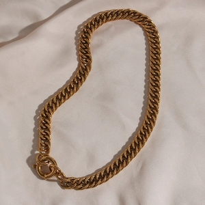 Detailed view of gold plated chunky chain necklace with large spring ring toggle clasp