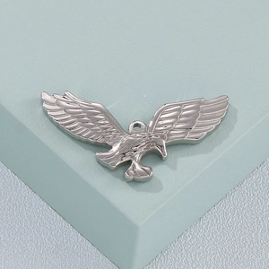 Polished silver eagle pendant with detailed feather carving in a soaring bird pose