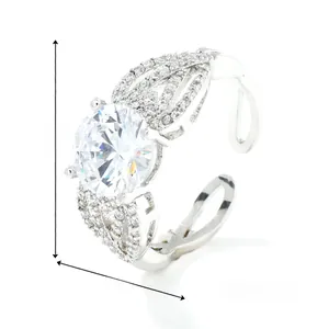 Detailed view of silver ring with large round zircon and intricate hollow woven band