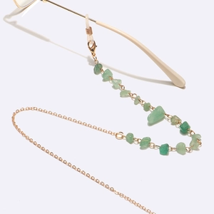 Detail of gold eyewear chain featuring natural green aventurine stones and anti-slip hooks
