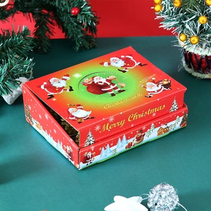 Close-up of red Christmas candle gift box with Santa motif and festive decor