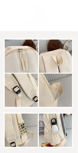 Details des cremefarbenen Canvas-Rucksacks mit geflochtenen Zippern und verstellbaren Gurten