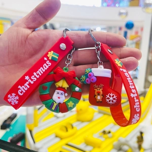 Christmas silicone keychains with Santa Claus and Reindeer icons on red wrist straps