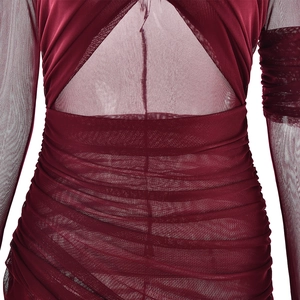 Close-up of wine red sheer mesh fabric with intricate pleated details and stitching texture