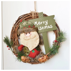 Close-up of a festive Christmas wreath with a plush Santa Claus and Merry Christmas sign