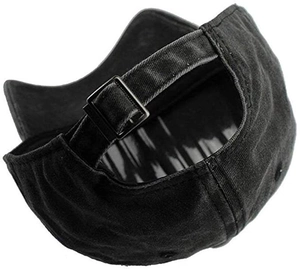 Detail view of the adjustable metal buckle strap on a black washed cotton baseball cap