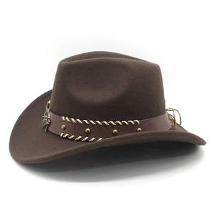 Detail of dark brown cowboy hat with leather band, metal studs and star ornament