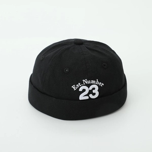 Detail of white embroidery Est. Number 23 on high-quality black cotton docker hat