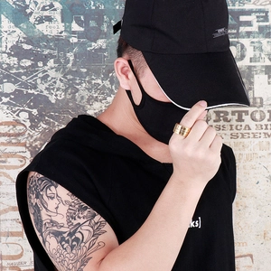 Street style shot of a gold rotatable spinner ring with Arabic numerals on a male model