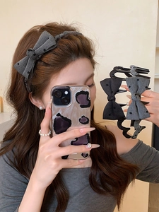 Polka dot bow headband worn by a model to showcase the high top hair styling effect