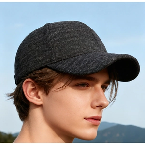 Detail of grey wool blend baseball cap with ear protection and textured tweed fabric
