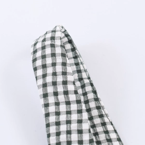 Close-up of green and white checkered cotton fabric straps for French style maxi dress