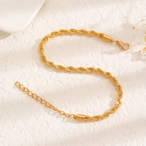 Detailed macro view of golden twisted rope chain with lobster clasp and extender
