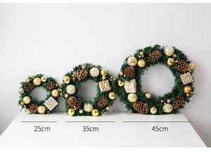Detailed view of artificial Christmas wreaths in three sizes with gold balls and pine cones