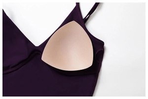 Detail view of removable foam pads and seamless purple fabric on sports yoga bra