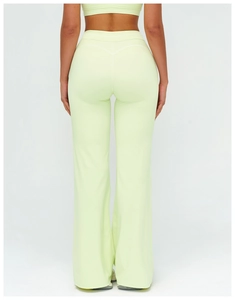 Rear view of high-waisted flare leggings in light green with V-shaped back stitching detail